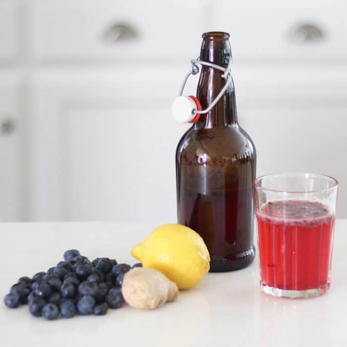 Ginger Berryade Kombucha recipe from @Meme // Living Well Kitchen is a fizzy, delicious, probiotic-filled explosion of the delicious flavors of berries, ginger, and lemonade. Save tons of money by making your own homemade kombucha! It's even tastier than the store bought drink. Video included!